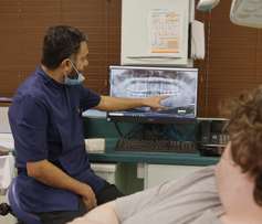 Dentist explaining X-ray to patient